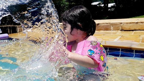 Full length of girl holding pink water