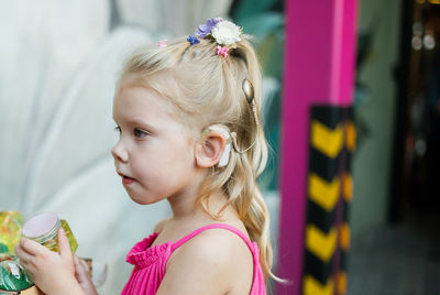 Side view of young woman holding bouquet