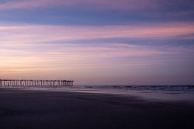 Scenic view of beach against sky during sunset