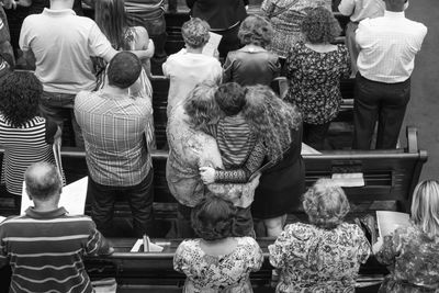 High angle view of people praying at church