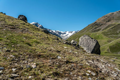 Scenic view of mountains against clear blue sky