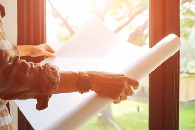 Close-up of hands holding window