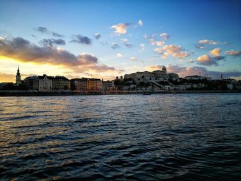 Scenic view of river against sky at sunset