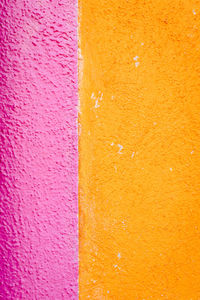 Close up of dwelling wall colored pink and yellow in burano