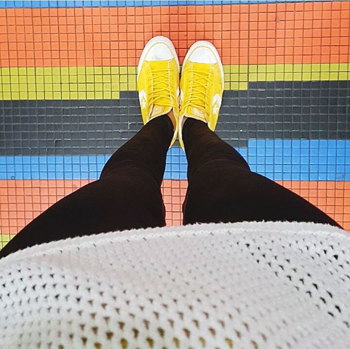 LOW SECTION OF PERSON STANDING ON YELLOW SHOES