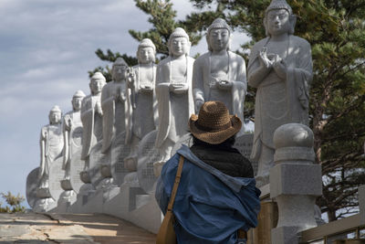 Rear view of a woman walking up in the temple. 