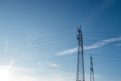 Low angle view of electricity pylon against sky