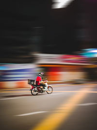 Blurred motion of man riding motorcycle