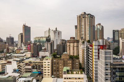 Modern buildings in city against sky