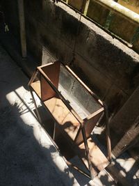 High angle view of empty bench on tiled floor