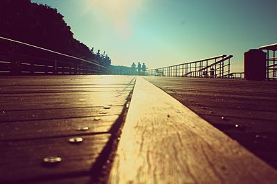 Surface level of footbridge against clear sky