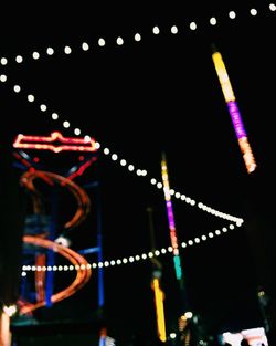 View of illuminated ferris wheel at night