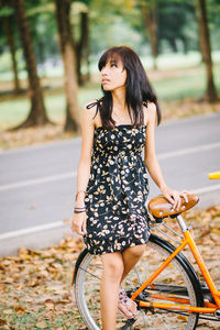 Portrait of young woman with bicycle