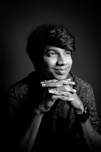 Close-up of young man against black background