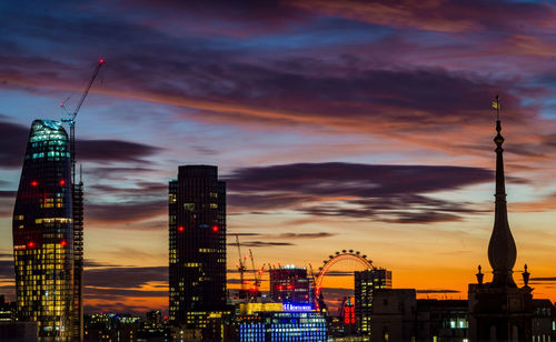 Illuminated city at sunset