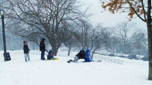 People walking on snow covered landscape