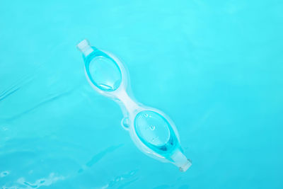 Swimming goggles floating in the pool