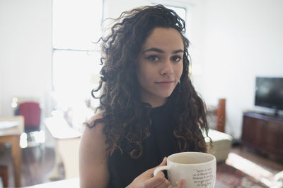 Portrait of woman drinking coffee