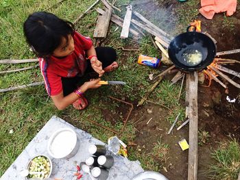 High angle view of girl preparing food in yard