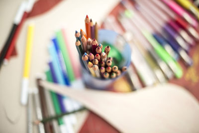 Close-up of colorful pencils in container on table