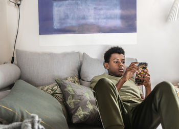 Teenage boy on sofa using cell phone