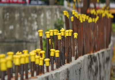 Close-up of yellow metal fence against blurred background