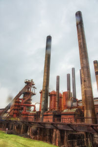 Low angle view of factory against sky