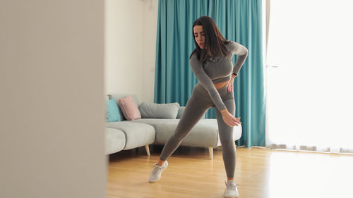 Portrait of young woman sitting on exercise mat