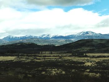 Scenic view of snowcapped mountains against sky