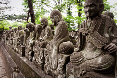 Sculpture of statues on tree