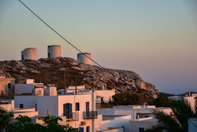 Buildings in village against clear sky