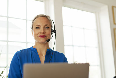 Woman in office with headset