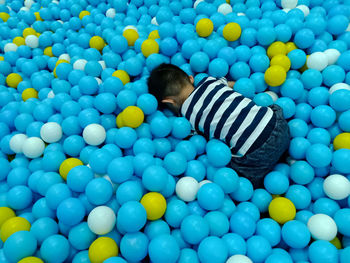 Rear view of boy at ball pool