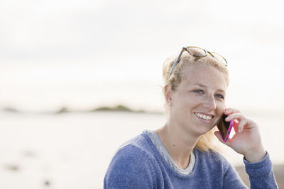 Smiling woman talking through phone