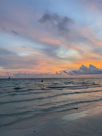 Scenic view of beach against sky during sunset