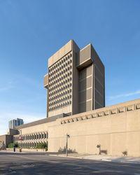 Low angle view of modern building against clear blue sky