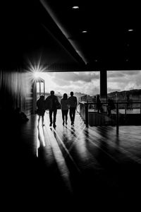 Rear view of silhouette people walking in corridor