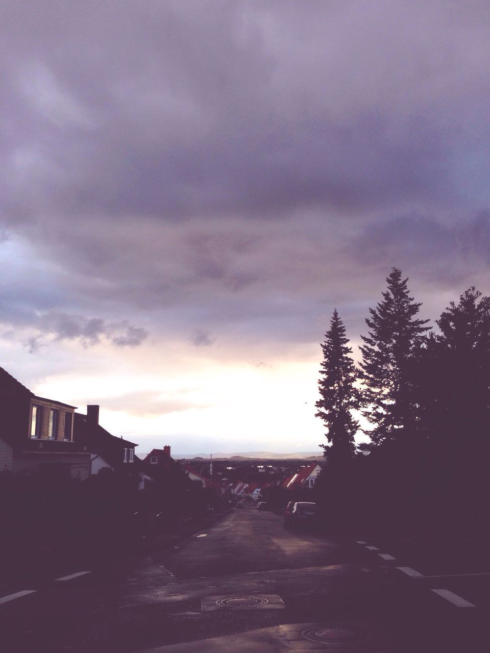 ROAD BY TREES AGAINST SKY