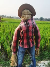 Rear view of person standing in farm