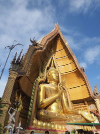 Low angle view of statue against temple building