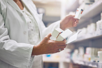 Midsection of scientist working in laboratory