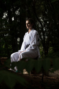 Young woman sitting on field