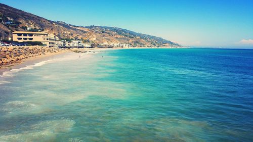 Scenic view of sea against clear blue sky