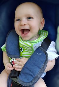 Cute happy toddler looking away on seat