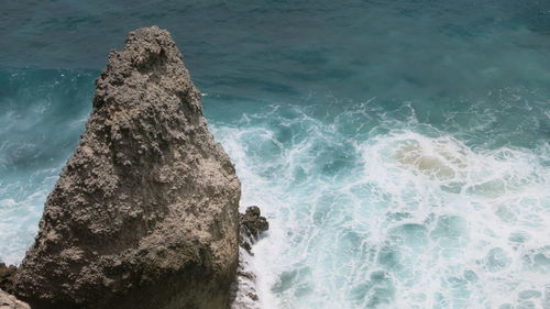 High angle view of rock in sea