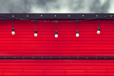 Low angle view of illuminated red lights hanging from ceiling