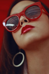 Close-up of teenage girl wearing red sunglasses