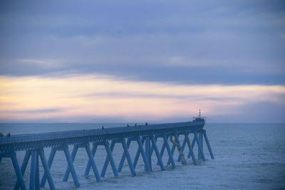 Pier over sea against sky