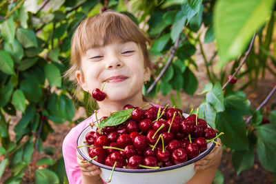 Portrait of cute girl holding fruit