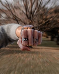 Close-up of human hand holding wood